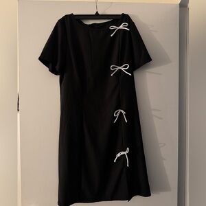 Elegant Black Dress with White Bow Accents